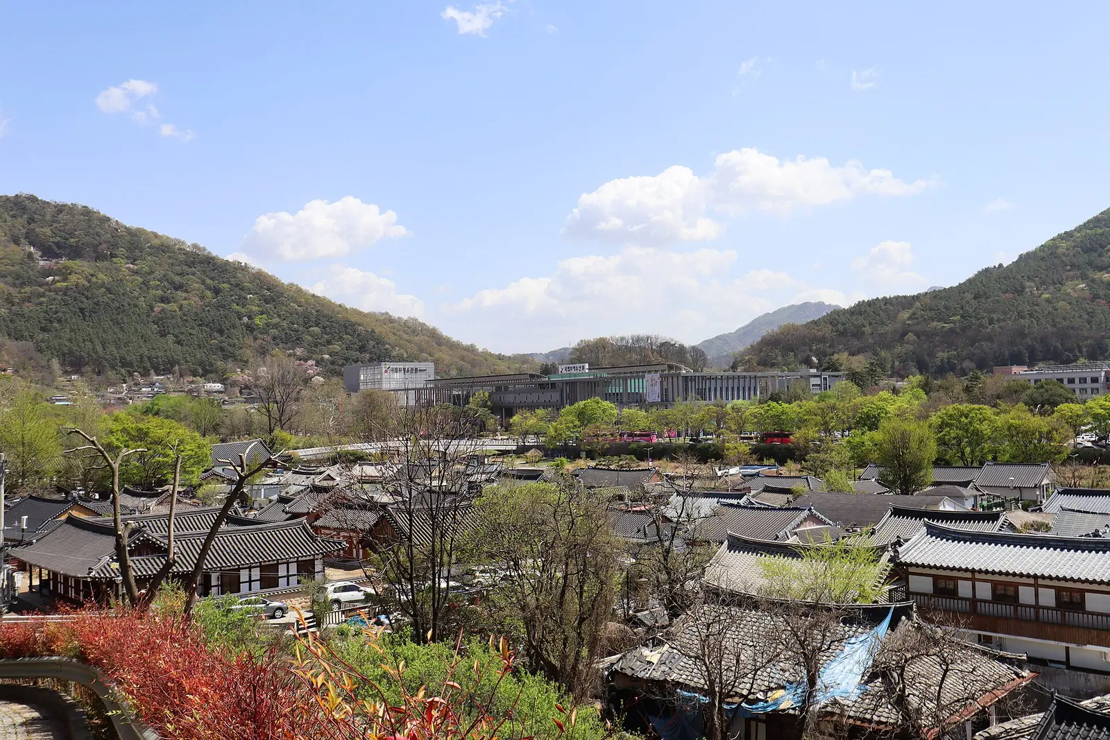 Tiled roofs of Jeonju Hanok Village with wooded hills behind