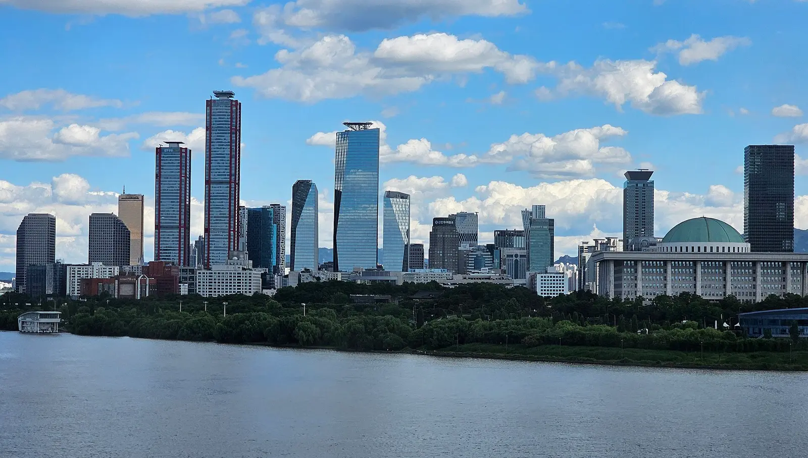 Yeouido skyscrapers across the Han River under a blue sky